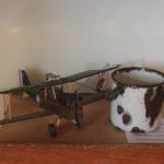 A biplane, probably made by one of the troops in the trenches. Next to the plane in the "Tommy's" drinking beaker.
